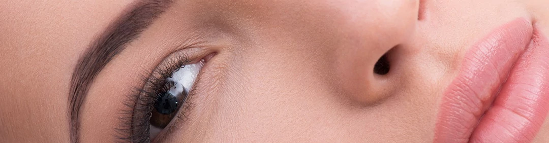 Pretty girl with artificial lashes at salon